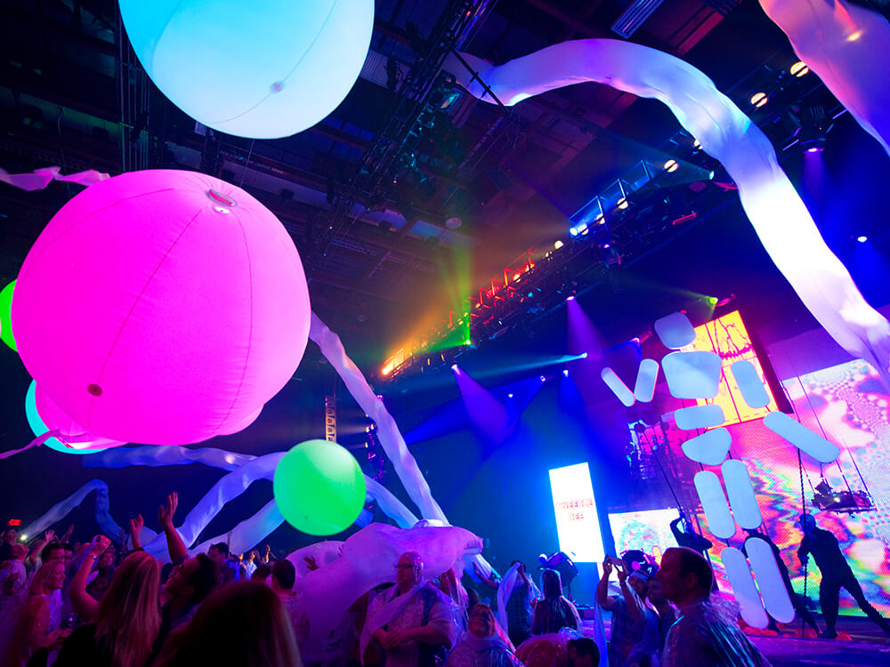 Giant fluorescent balloons bounce through the audience at a Blue Man Group show in Universal’s CityWalk.